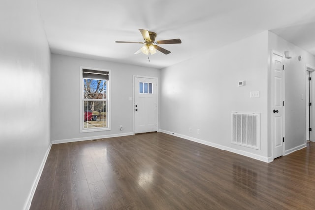 unfurnished room with dark wood-type flooring and ceiling fan