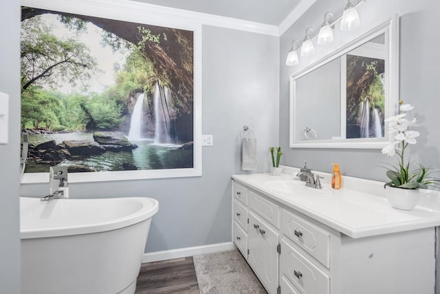 bathroom featuring hardwood / wood-style flooring, vanity, ornamental molding, and a bath