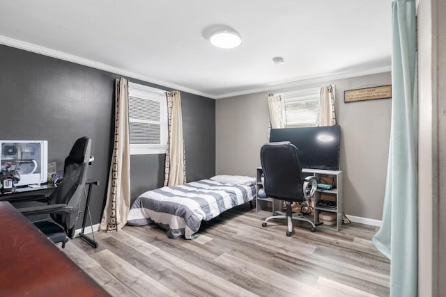 bedroom featuring crown molding and light wood-type flooring