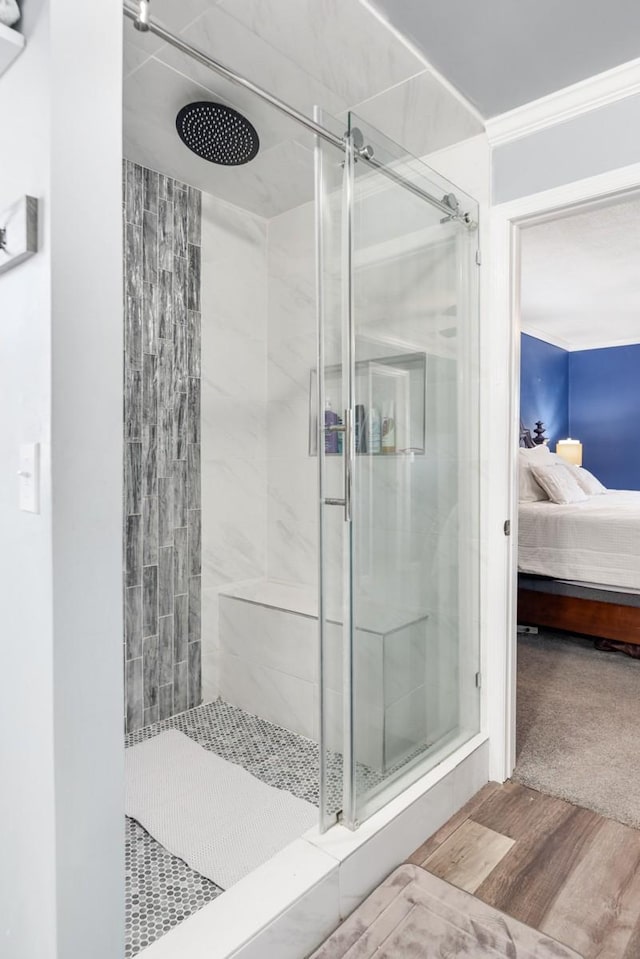 bathroom with crown molding and walk in shower