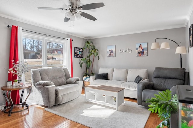 living room featuring crown molding, hardwood / wood-style flooring, and ceiling fan