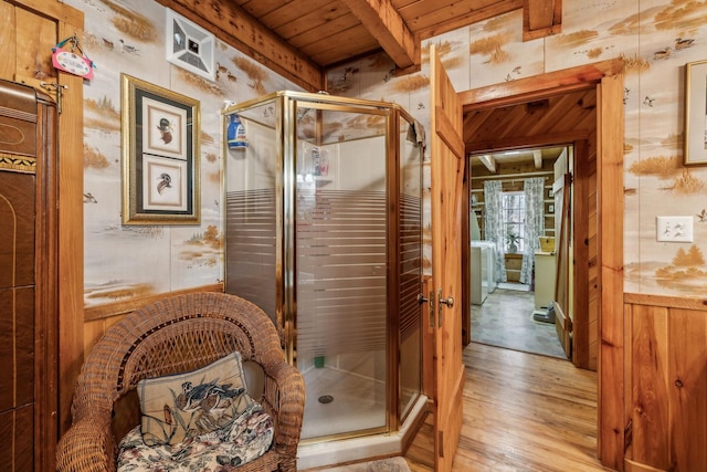 bathroom featuring walk in shower, wooden ceiling, wooden walls, beam ceiling, and hardwood / wood-style floors