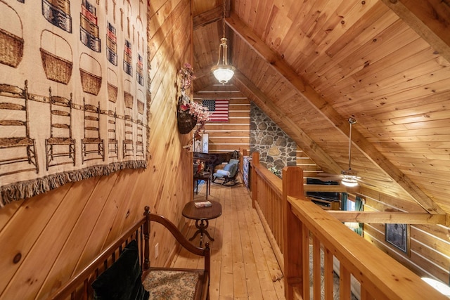 interior space with lofted ceiling with beams, wood ceiling, wooden walls, and light hardwood / wood-style floors