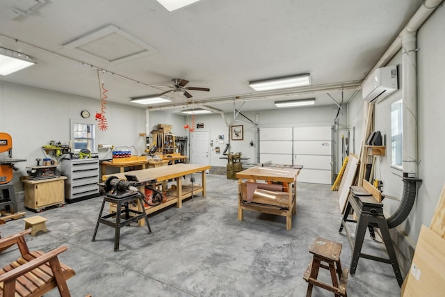 garage with a wall unit AC and a workshop area