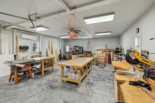 misc room with concrete flooring, a wall mounted AC, and a workshop area