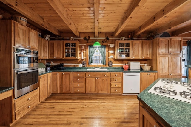 kitchen featuring wood ceiling, dishwasher, double oven, beam ceiling, and light hardwood / wood-style floors