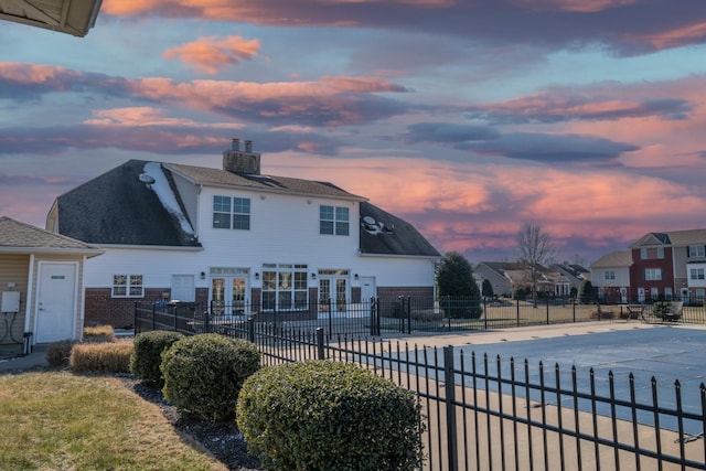 pool at dusk with french doors