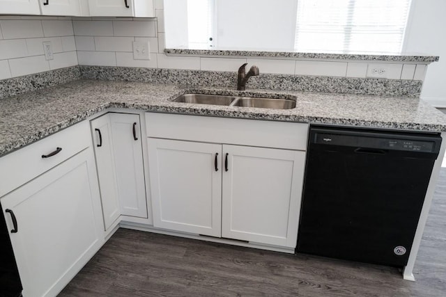 kitchen with dark wood-type flooring, sink, light stone counters, dishwasher, and white cabinets