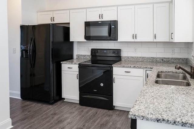 kitchen featuring dark hardwood / wood-style floors, white cabinetry, sink, light stone counters, and black appliances