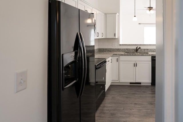 kitchen with tasteful backsplash, white cabinets, sink, and black appliances