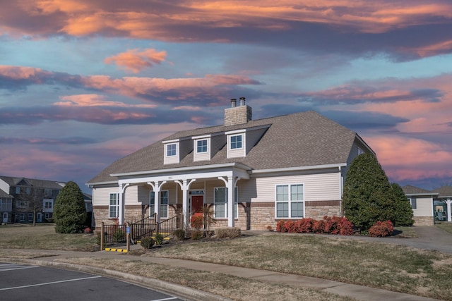 view of front of home featuring a porch and a lawn