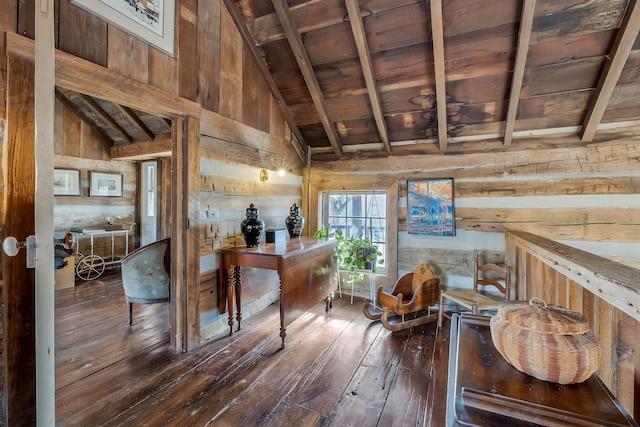 interior space with beam ceiling, wood ceiling, dark wood-type flooring, and wood walls