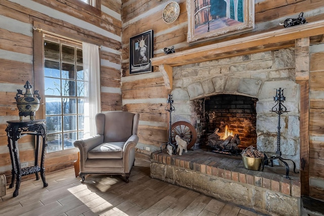 living area with a fireplace and wood walls