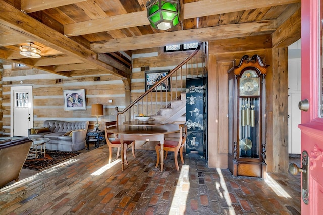 dining space featuring wood ceiling and wood walls