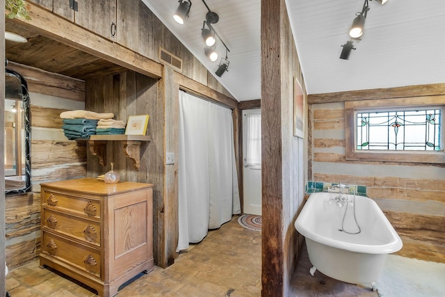 bathroom featuring wood ceiling, vaulted ceiling, and a tub