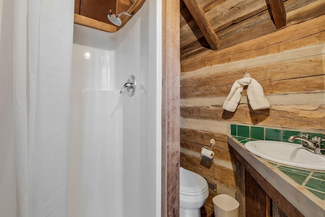 bathroom featuring a shower, sink, wooden walls, and toilet