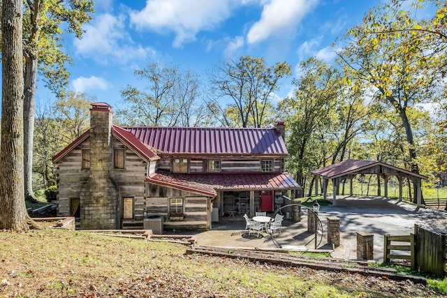 rear view of house with a gazebo and central AC