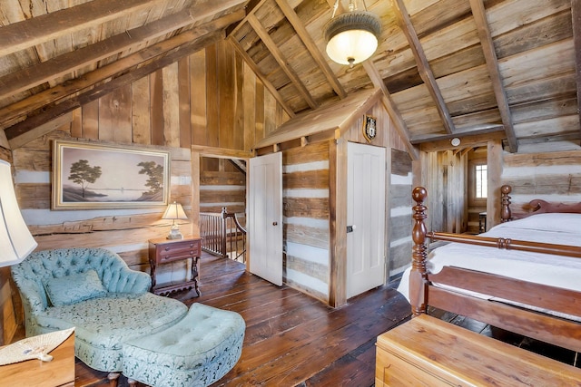 bedroom featuring wooden walls, lofted ceiling with beams, and wooden ceiling