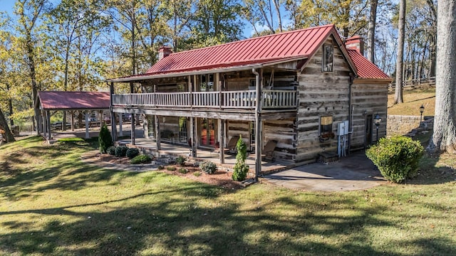 rear view of property with a patio area and a lawn