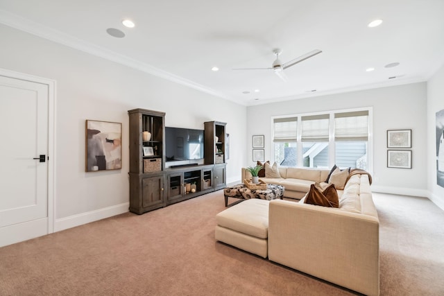 carpeted living room with ceiling fan and ornamental molding