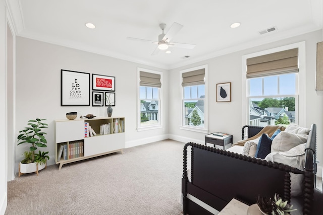 interior space featuring ceiling fan, ornamental molding, and carpet