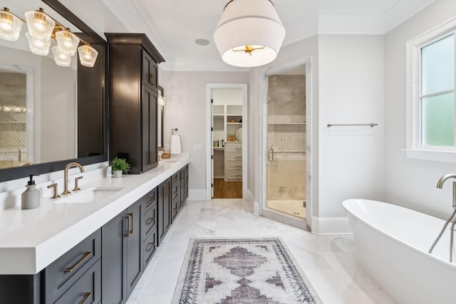 bathroom featuring vanity, ornamental molding, and separate shower and tub