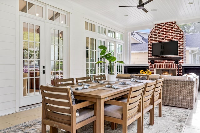 sunroom / solarium with an outdoor brick fireplace, ceiling fan, and wood ceiling