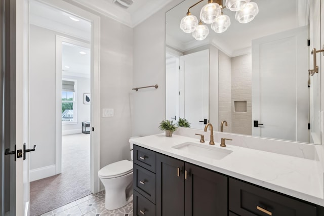 bathroom featuring vanity, ornamental molding, and toilet