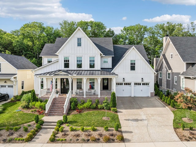 modern farmhouse style home with a garage, covered porch, and a front lawn