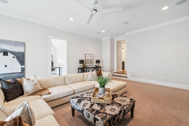 carpeted living room with crown molding and ceiling fan