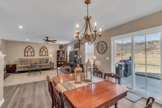 dining area with ceiling fan and light hardwood / wood-style floors