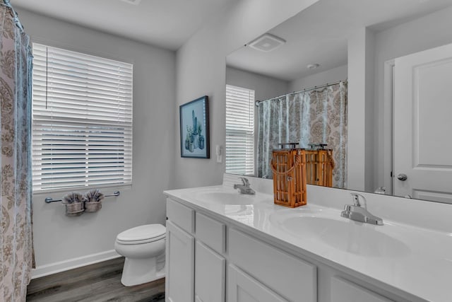 bathroom featuring vanity, wood-type flooring, and toilet