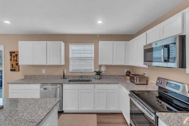 kitchen featuring white cabinetry, stainless steel appliances, and sink