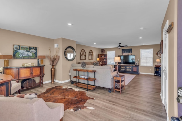 living room featuring ceiling fan and light wood-type flooring