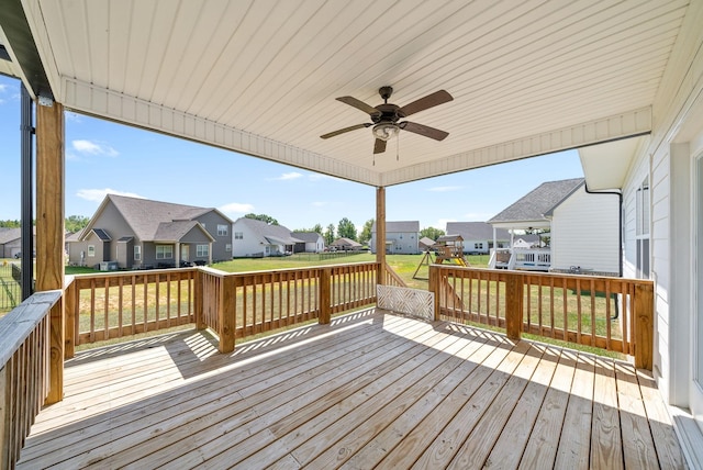 wooden deck featuring a yard and ceiling fan