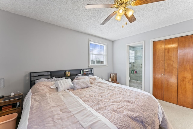 bedroom featuring a closet, a textured ceiling, ceiling fan, and ensuite bath