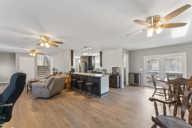 living room with hardwood / wood-style flooring and ceiling fan