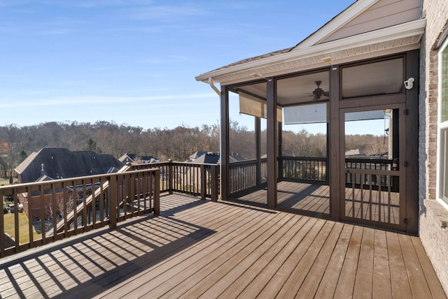 deck with a sunroom and ceiling fan