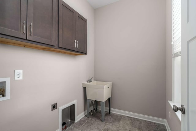 laundry room with cabinets, electric dryer hookup, and hookup for a washing machine