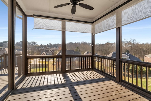 unfurnished sunroom with ceiling fan