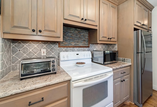 1704 Temple Ave, Nashville, TN 37215 - kitchen featuring backsplash, stainless steel appliances, light hardwood / wood-style floors, and light stone countertops