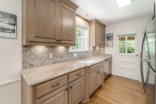 1704 Temple Ave, Nashville, TN 37215 - kitchen featuring a healthy amount of sunlight, stainless steel appliances, light stone countertops, and sink