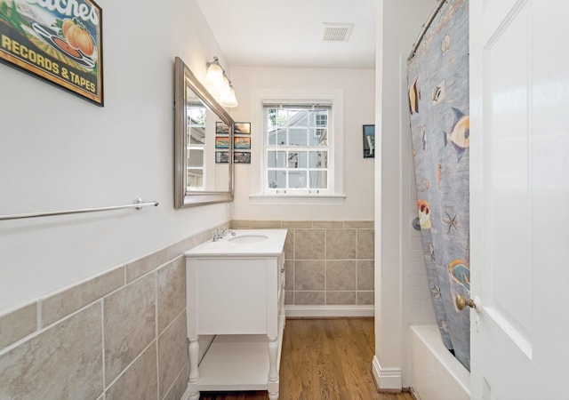 1704 Temple Ave, Nashville, TN 37215 - bathroom with shower / bath combo with shower curtain, vanity, hardwood / wood-style floors, and tile walls