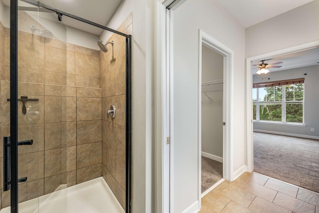 bathroom featuring tile patterned flooring, a shower with door, and ceiling fan