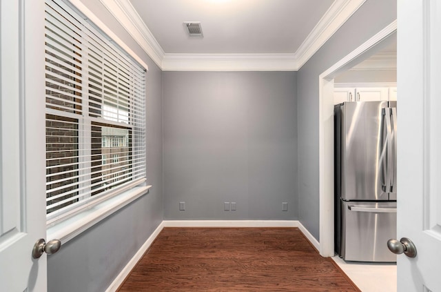 unfurnished room with crown molding and wood-type flooring