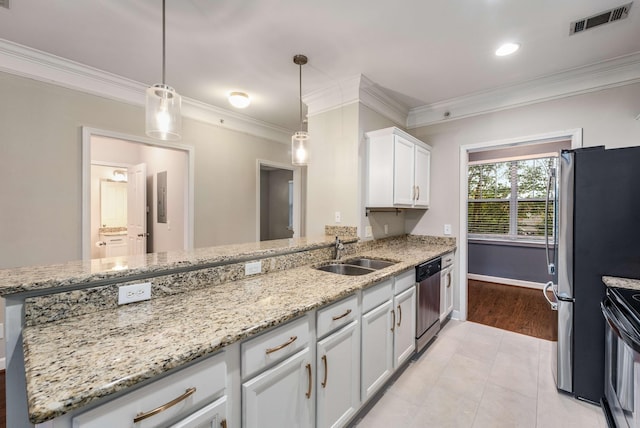 kitchen with sink, white cabinetry, stainless steel appliances, light stone countertops, and decorative light fixtures