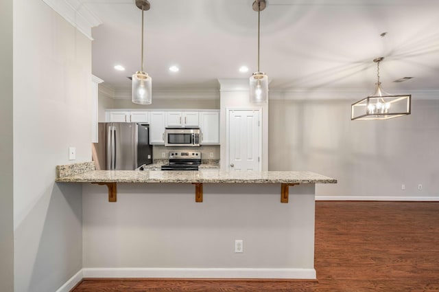 kitchen featuring a breakfast bar area, white cabinetry, decorative light fixtures, kitchen peninsula, and stainless steel appliances