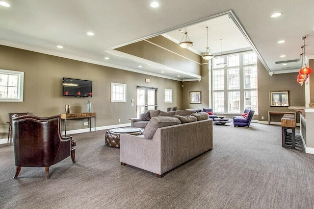 carpeted living room featuring crown molding and a healthy amount of sunlight