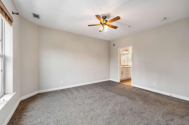 carpeted spare room with ceiling fan