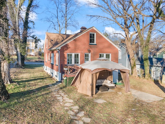 back of property with a gazebo